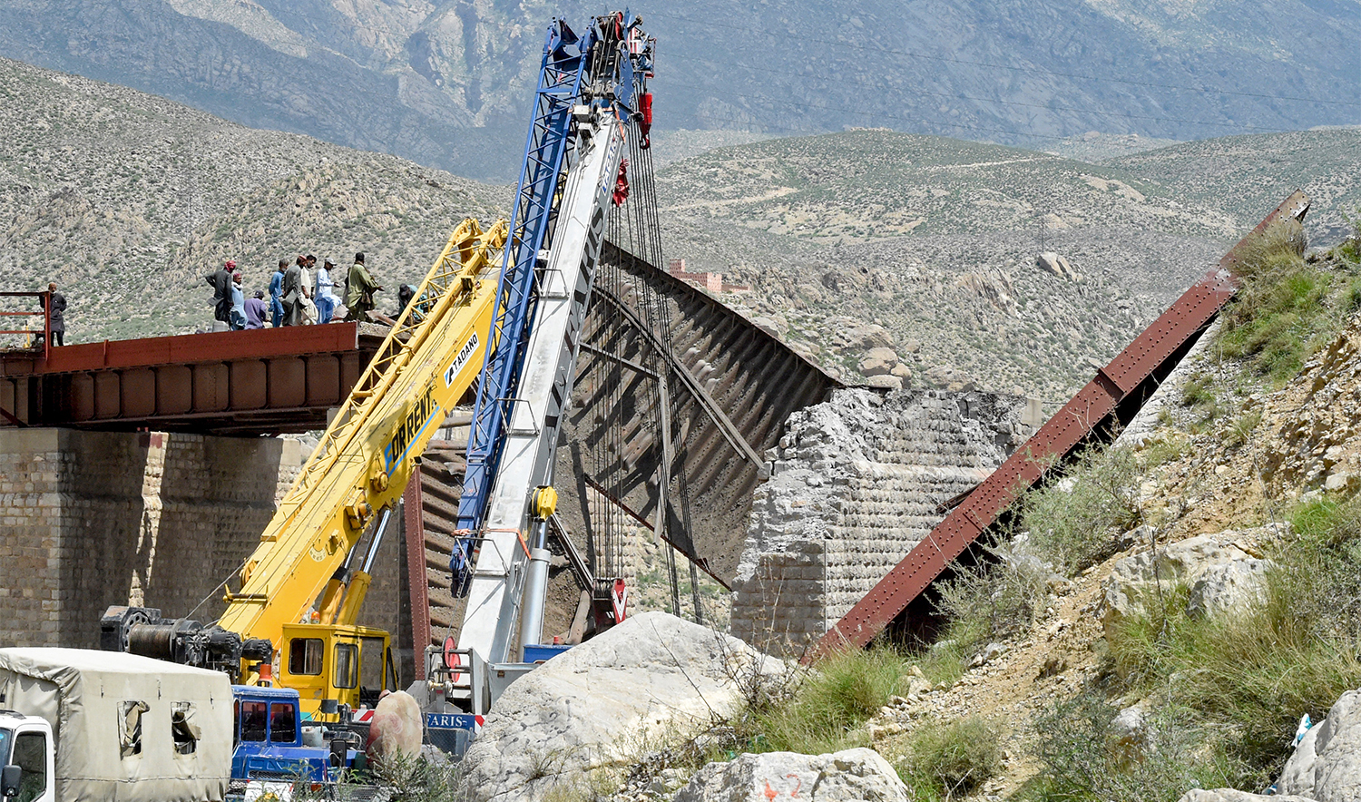 Railway officials inspect the remains of a collapsed railway bridge the morning after a blast by separatist militants at Kolpur in Bolan district, Balochistan province on August 27, 2024. (AFP/File)