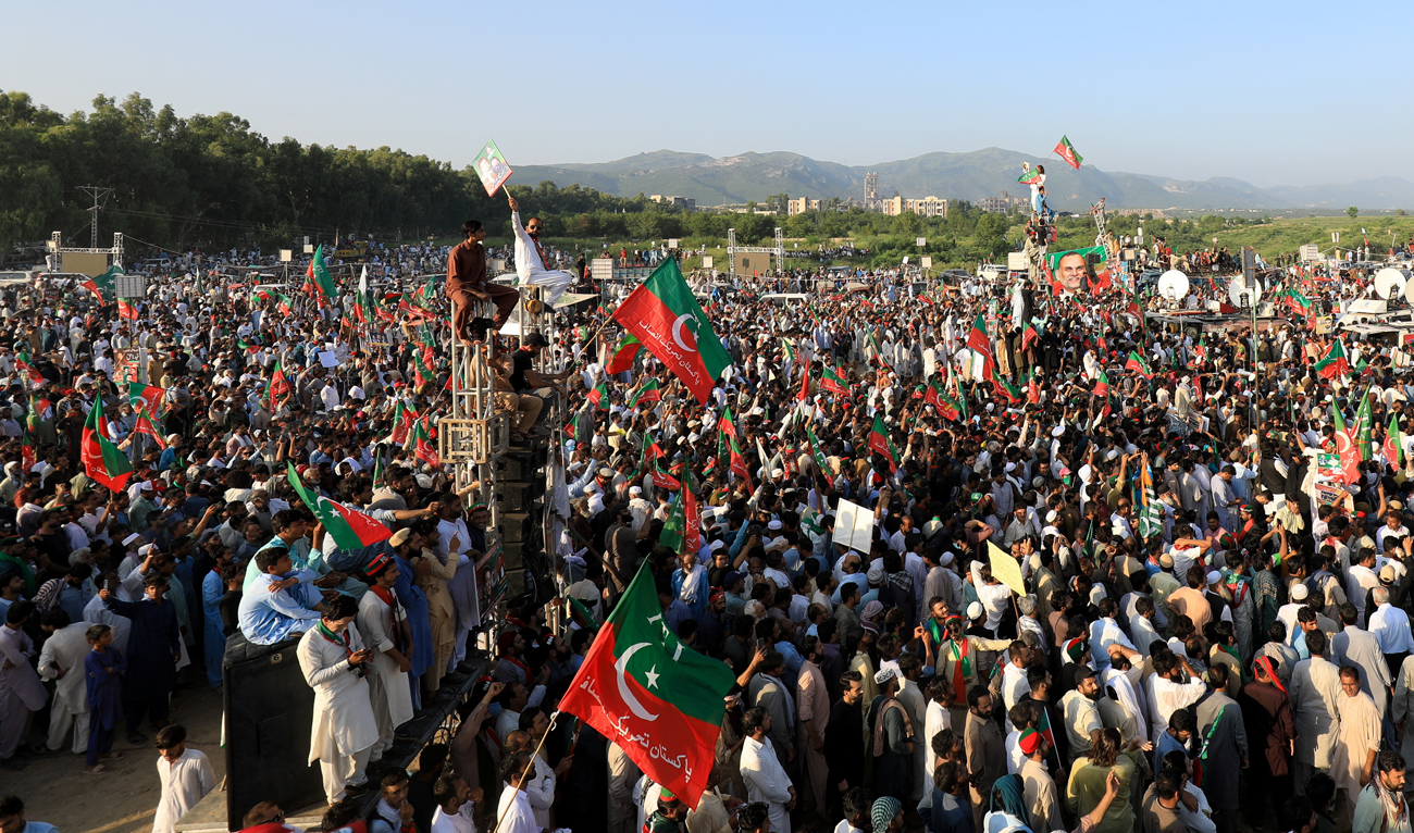 In this file photo taken on September 8, 2024, supporters of jailed former Pakistani Prime Minister Imran Khan’s party, the Pakistan Tehreek-e-Insaf (PTI), wave party flags during a rally in Islamabad. (REUTERS/File)