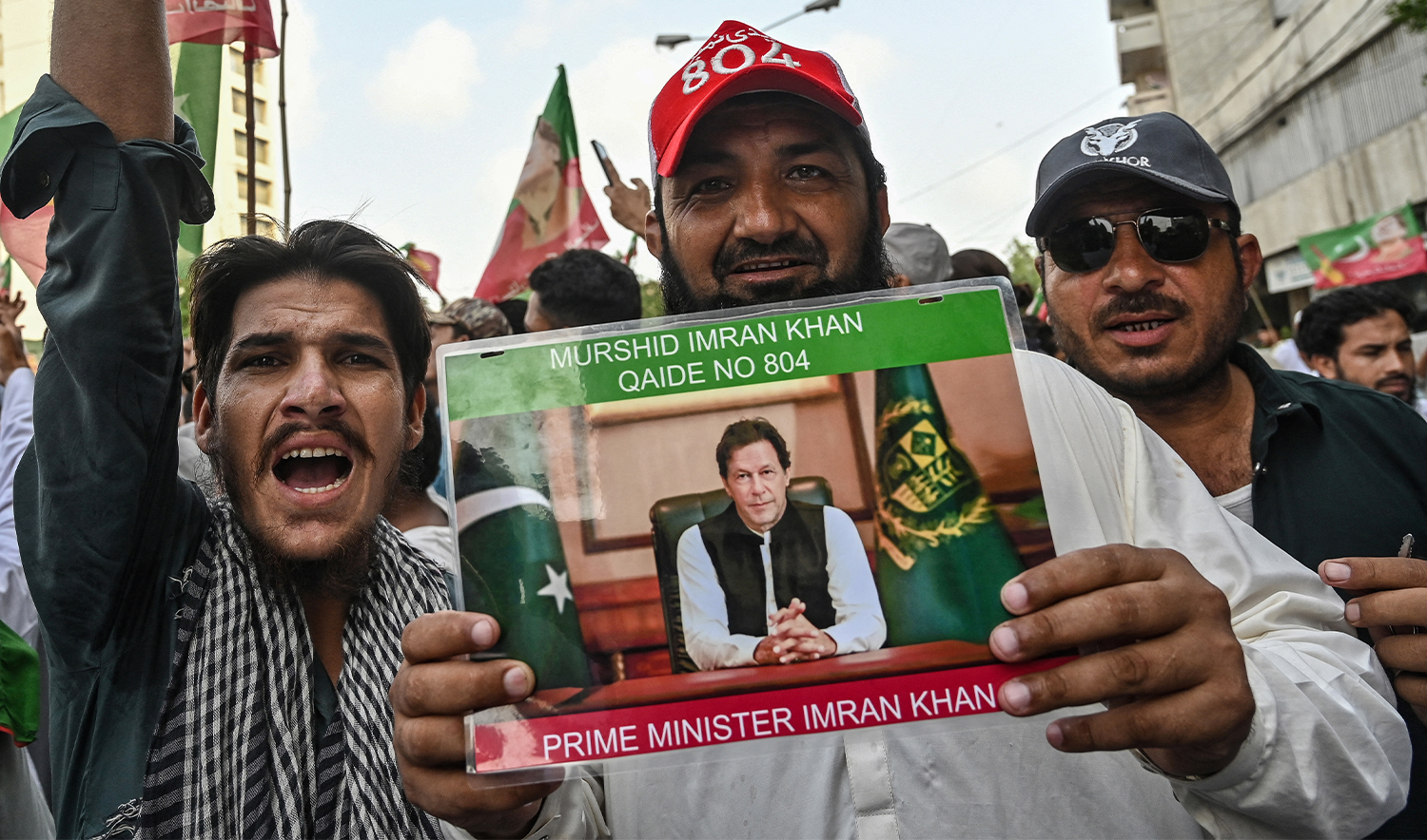 Activists and supporters of the Pakistan Tehreek-e-Insaf (PTI) party hold a poster of jailed former prime minister Imran Khan as they take part in a protest demanding Khan's release in Karachi on July 26, 2024. (AFP/File)
