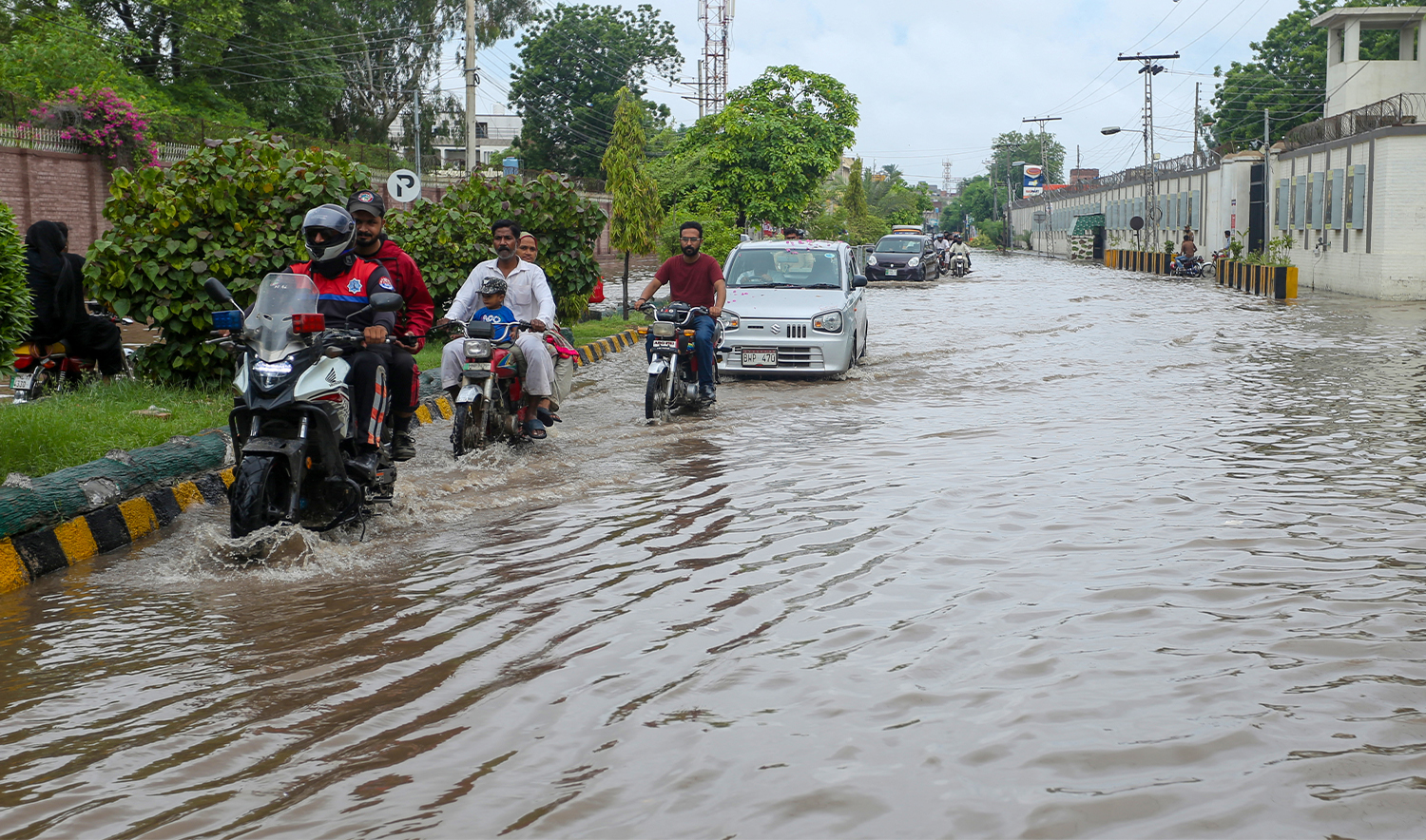 Commuters wade through flood waters after heavy monsoon rains in Multan on August 30, 2024. (AFP/File)