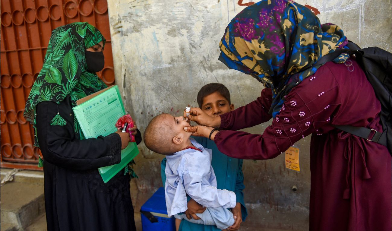 A health worker administers polio drops to a child during a door-to-door vaccination campaign in Karachi on October 2, 2023. (AFP/File)
