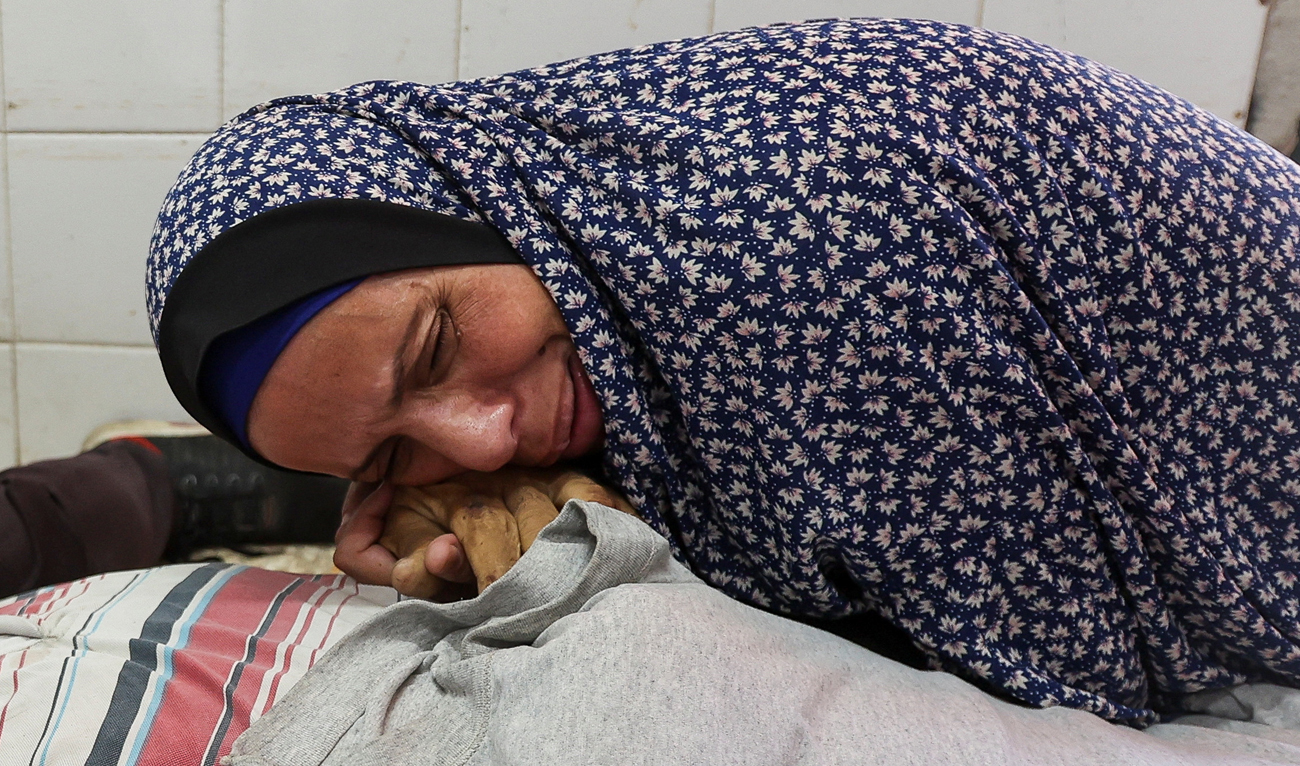 The sister of Palestinian Adel Al-ejla, who was killed in an Israeli strike, reacts over his body, amid the Israel-Hamas conflict, at Al-Aqsa Martyrs Hospital in Deir Al-Balah in the central Gaza Strip on September 25, 2024. (REUTERS)