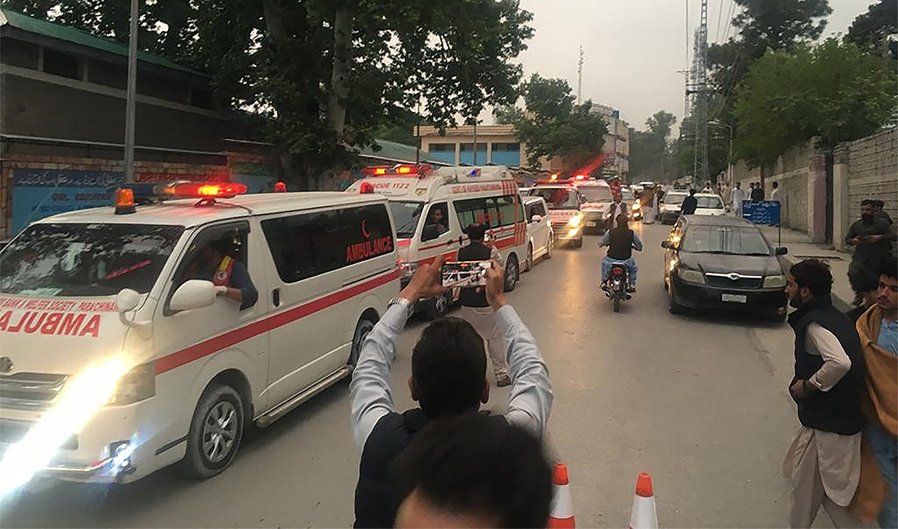 Ambulances carry victims' coffins of those who were killed in the sectarian violence inside a school, in Parachinar on May 4, 2023. (AFP/File)