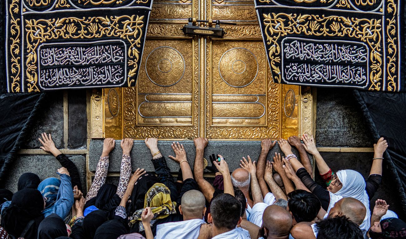 Muslim worshippers reach to touch the golden doors Kaaba, Islam's holiest shrine, while performing the "Umrah" pilgrimage circumambulation or "tawaf", circling seven times around it at the Grand Mosque in the holy city of Mecca on September 6, 2023. (AFP/File)