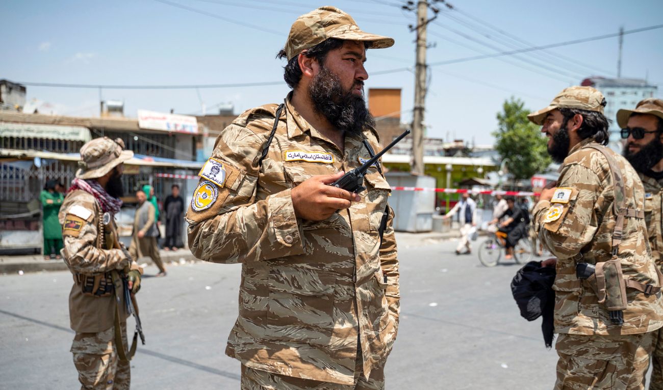 Taliban security personnel stand guard along a street as Afghan Shiite Muslim mourners carry out a procession to celebrate Ashura on the tenth day of the Islamic month of Muharram in Pol-e-Sokhta neighbourhood of Kabul on July 16, 2024. (AFP/File)