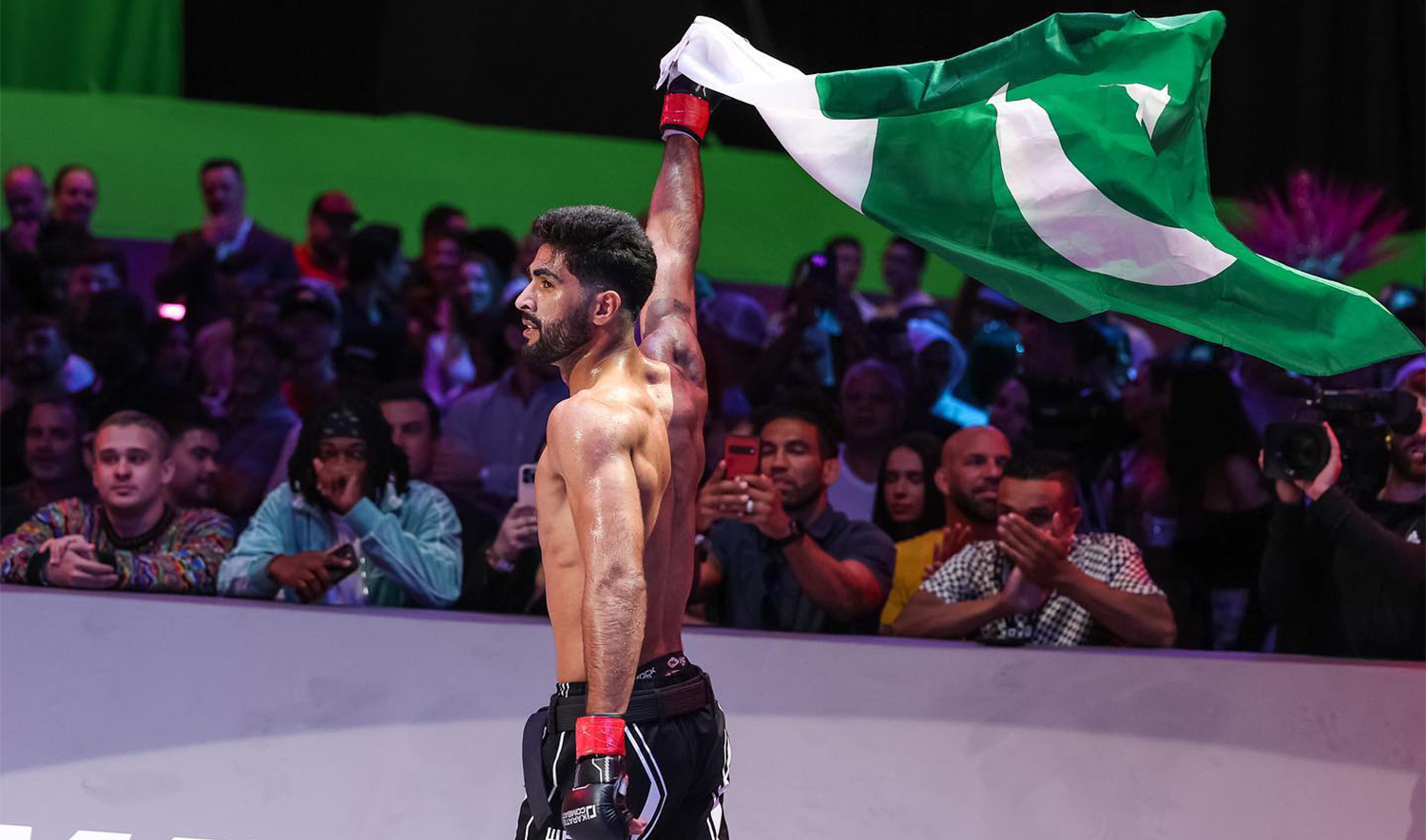 The picture posted on April 13, 2023, shows Pakistani ‘Karate Kid’ Shahzaib Rind holding Pakistani flag after winning a fight in US. (Shahzaib Rind)