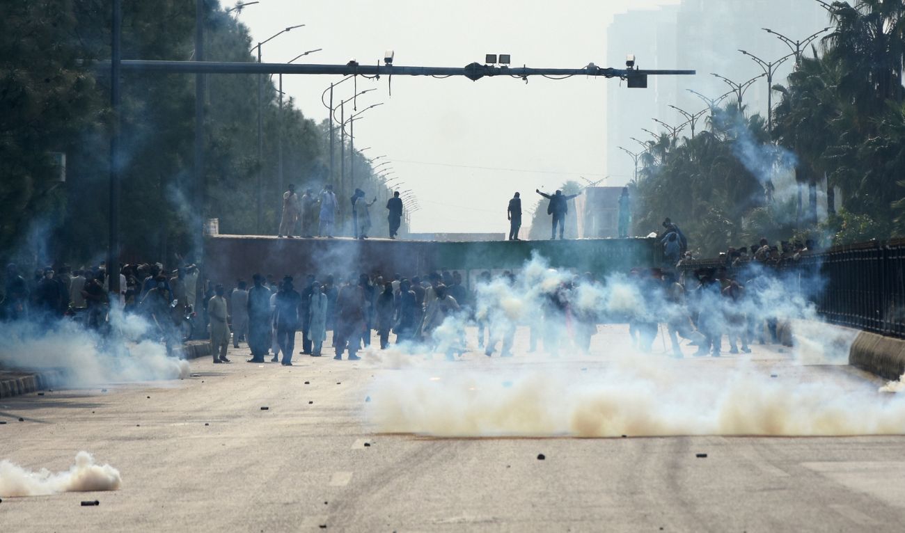 Police officers fire tear gas to disperse the supporters of imprisoned, former Prime Minister Imran Khan's party Pakistan Tehreek-e-Insaf, during a protest in Islamabad, Pakistan, Saturday, Oct. 5, 2024. (AFP)
