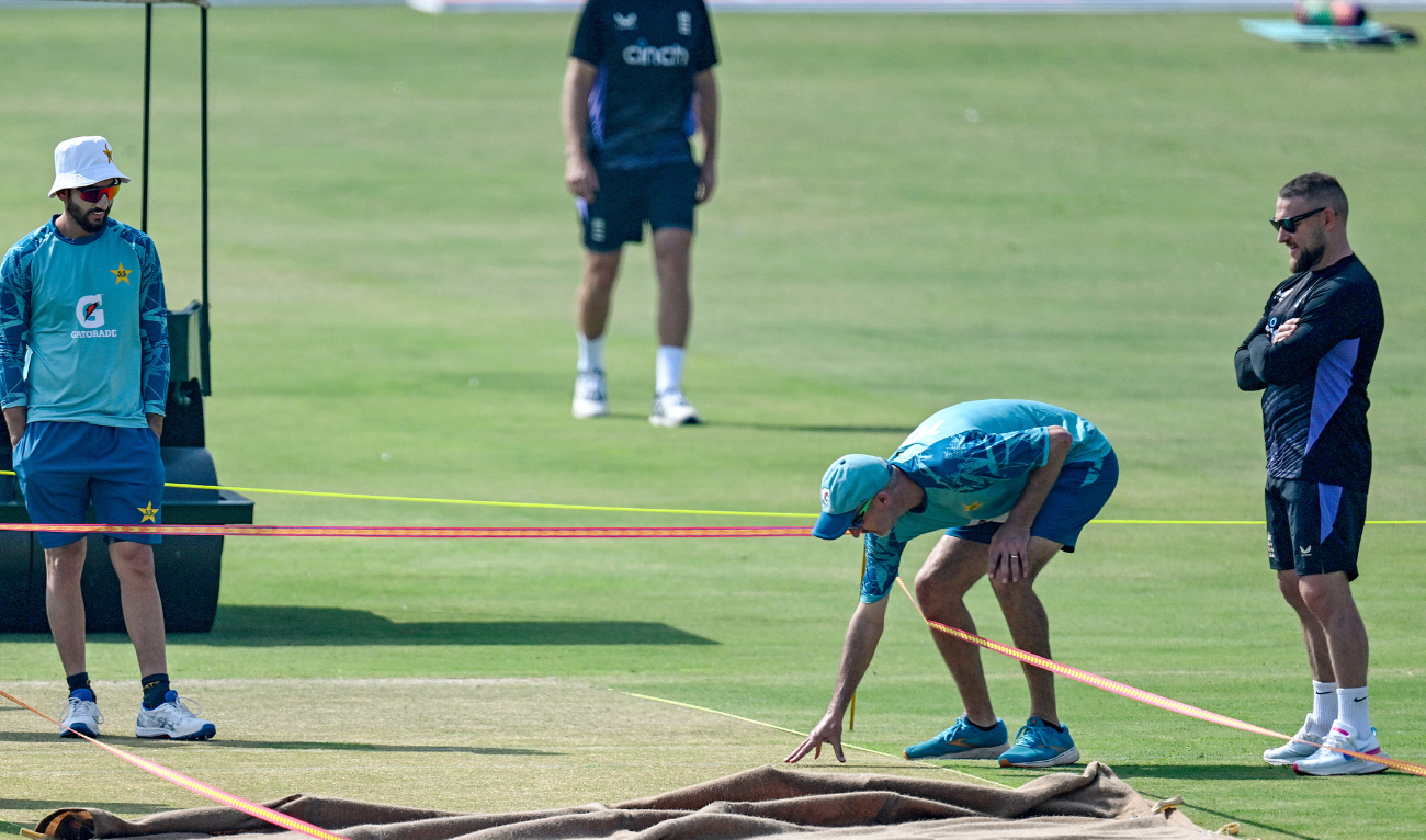 England's head coach Brendon McCullum (R) and his Pakistani counterpart Jason Gillespie (2R) inspect the pitch during a practice session on the eve of their first Test cricket match at the Multan Cricket Stadium in Multan on October 6, 2024. (AFP/File)