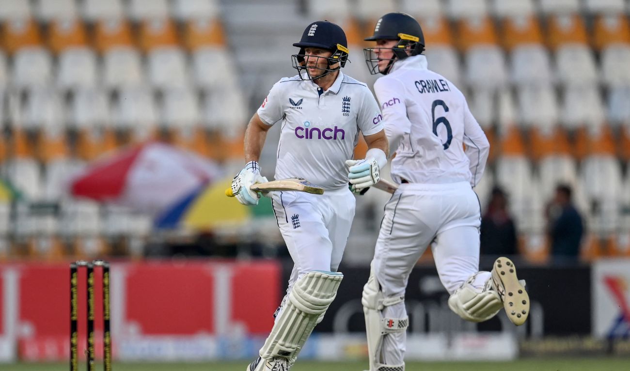 England's Joe Root and Zak Crawley (R) run between the wickets during the second day of the first Test cricket match between Pakistan and England at the Multan Cricket Stadium in Multan on October 8, 2024. (AFP)