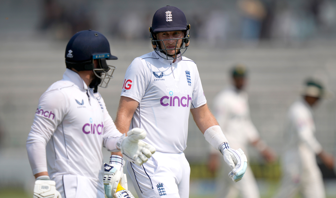 England’s Joe Root, right, chat with Ben Duckett as they walk off the field on the lunch break during the third day of the first test cricket match between Pakistan and England, in Multan on October 9, 2024. (AP)