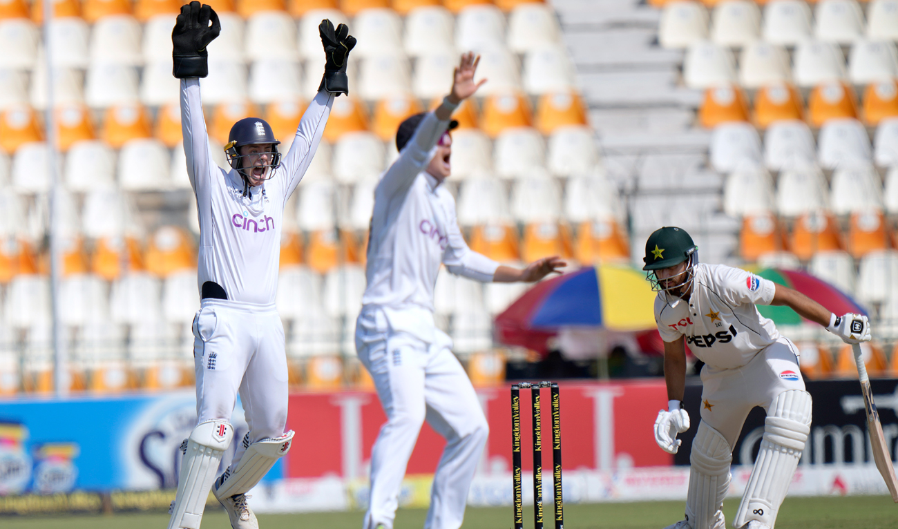 England’s Jamie Smith, left, and Ollie Pope, center, appeal for LBW out of Pakistan’s Salman Ali Agha during the fifth day of the first test cricket match between Pakistan and England, in Multan on October 11, 2024. (AP)