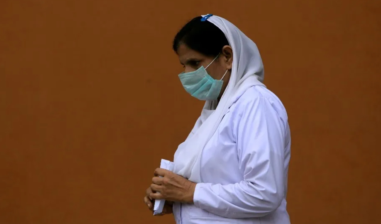In this file photo, taken on March 4, 2020, a nurse wears a face mask as she walks at the premises of the Lady Reading Hospital in Peshawar. (REUTERS/File)