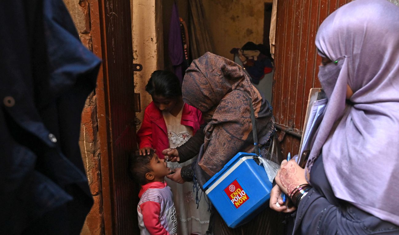 A health worker administers polio vaccine drops to a child during a vaccination campaign in Lahore on January 16, 2023. (AFP/File)