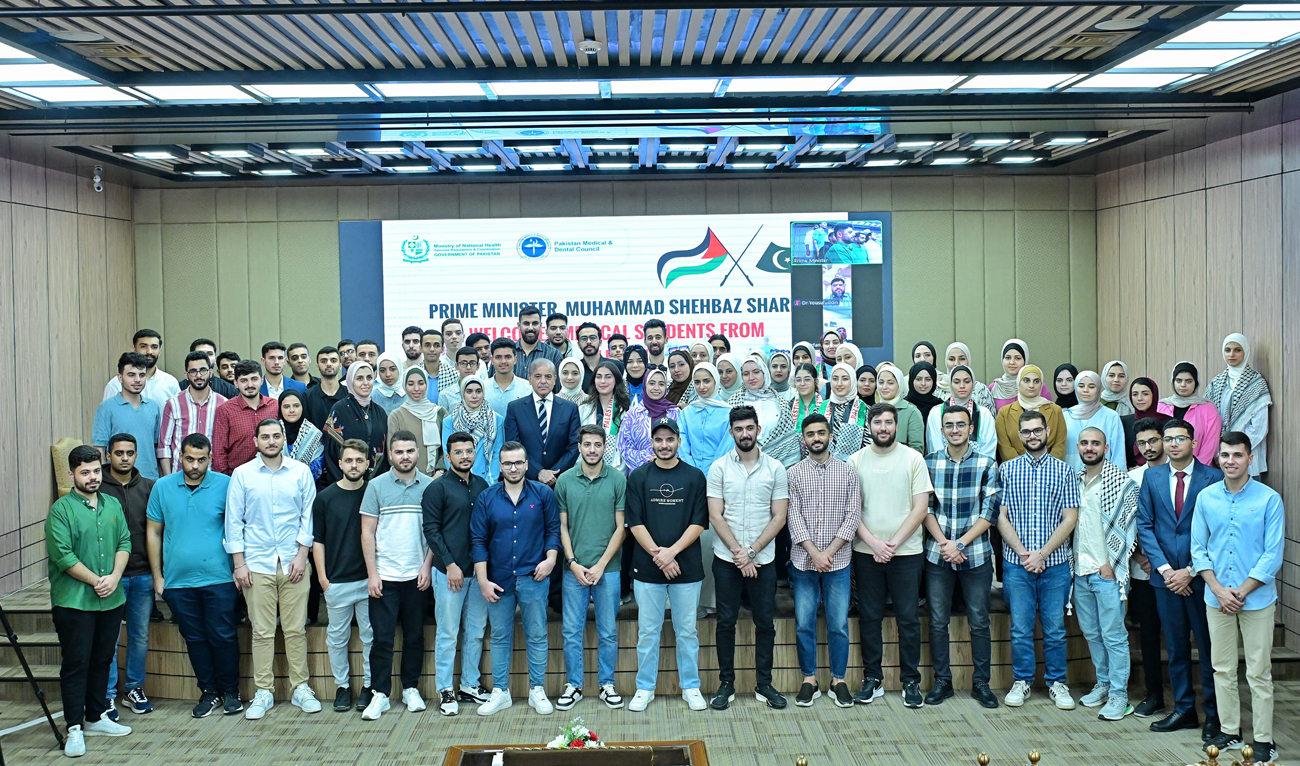 Pakistan Prime Minister Shehbaz Sharif gestures for a group with Palestinian students arrive in Pakistan to complete their studies, in Islamabad on October 23, 2024. (Photo courtesy: PMO)