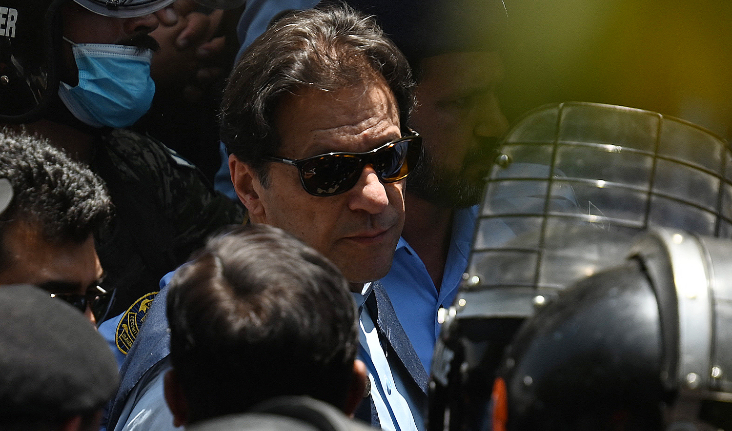 Police cammandos escort former Pakistan's Prime Minister Imran Khan (C) as he arrives at the high court in Islamabad on May 12, 2023. (AFP/File)