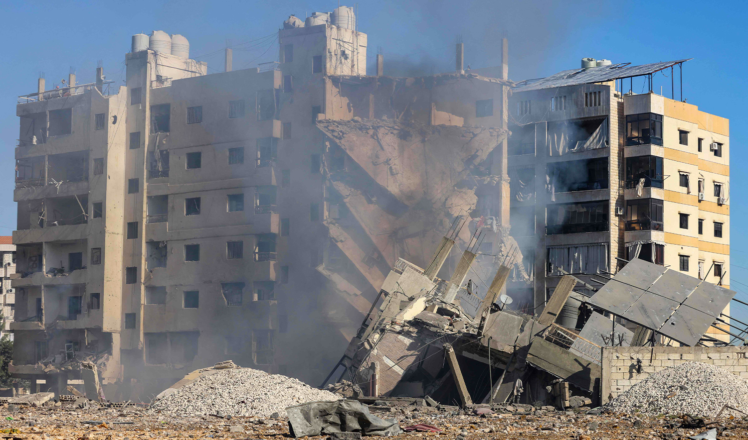 This picture shows the rubble of destroyed buildings the site of last night's Israeli airstrike that targeted the Laylaki neighbourhood in Beirut's southern suburbs on October 24, 2024. (AFP)