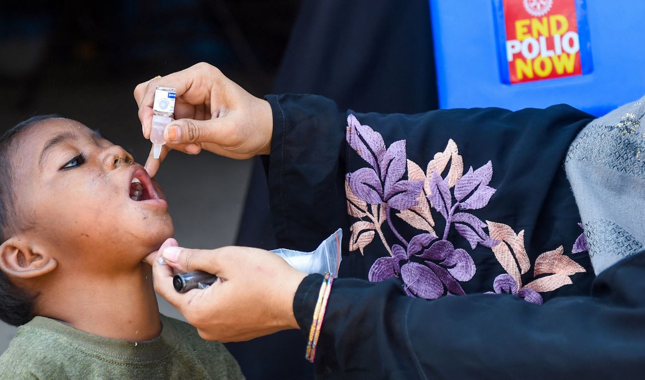 A health worker administers polio vaccine drops to a child during a vaccination campaign in Karachi on October 24, 2022. (AFP/ File)