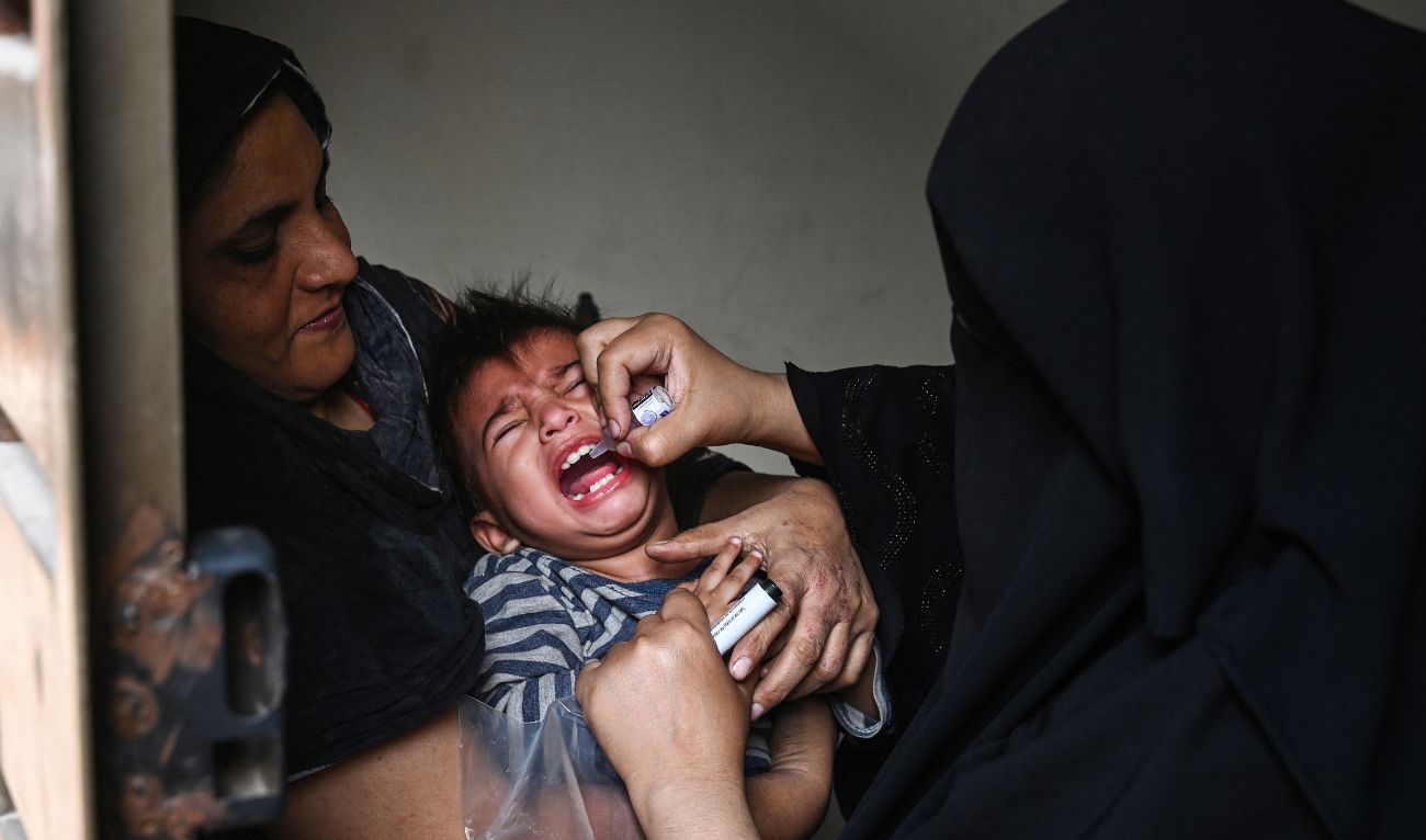 A health worker administers polio drops to a child during a door-to-door vaccination campaign in Lahore on October 28, 2024. (AFP)