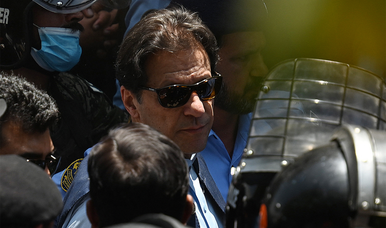 Police cammandos escort former Pakistan's Prime Minister Imran Khan (C) as he arrives at the high court in Islamabad on May 12, 2023. (AFP/File)