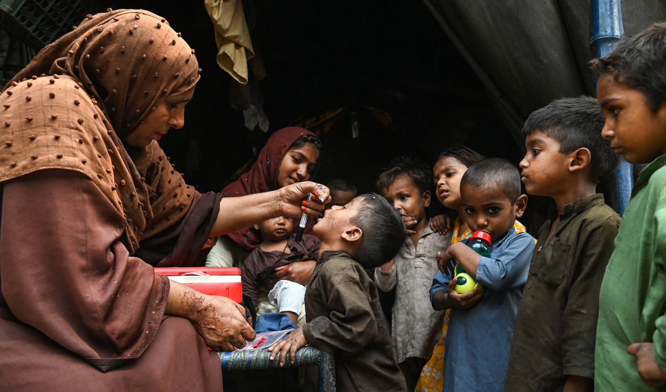 Health workers administer polio drops to children during a door-to-door vaccination campaign in Lahore on October 28, 2024. (AFP)