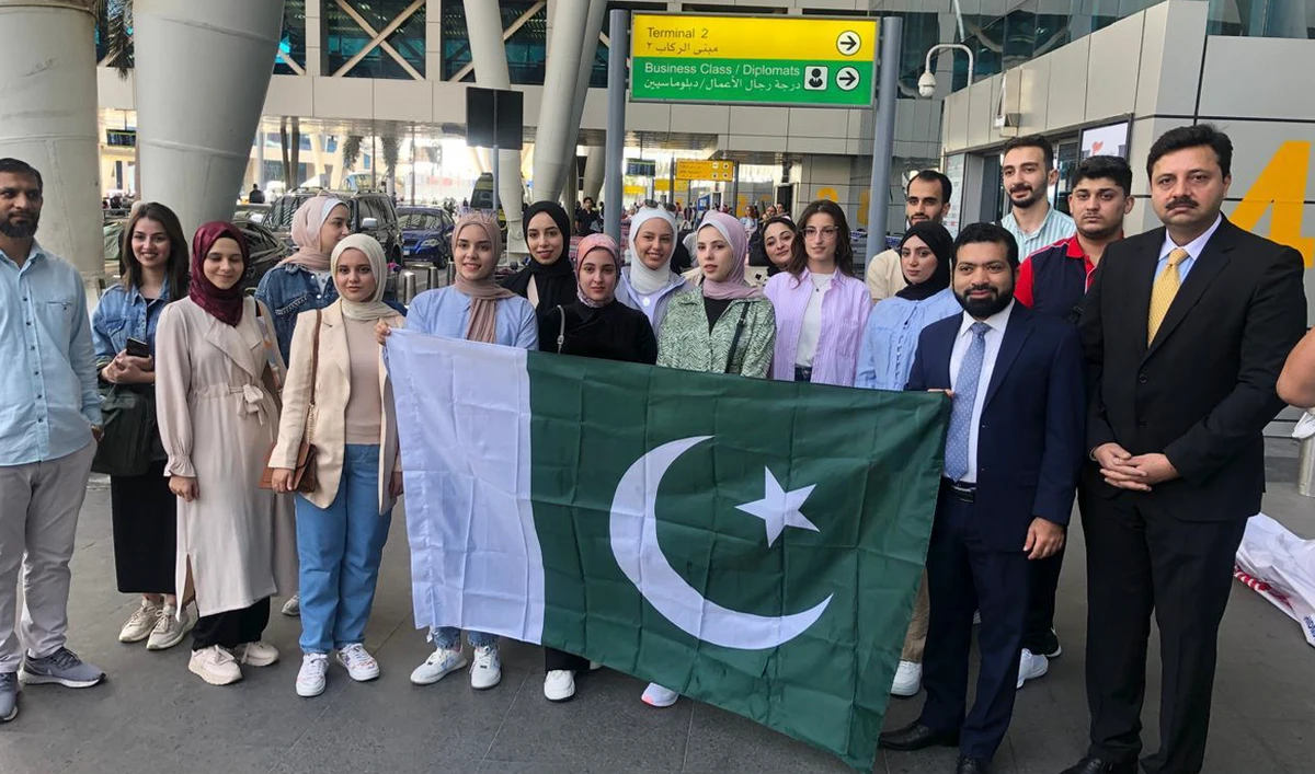 This handout photo, taken and released by Pakistan embassy in Egypt, shows first group of Palestinian students departing for Pakistan, in Cairo on October 12, 2024. (Photo courtesy: @PakinEgypt)