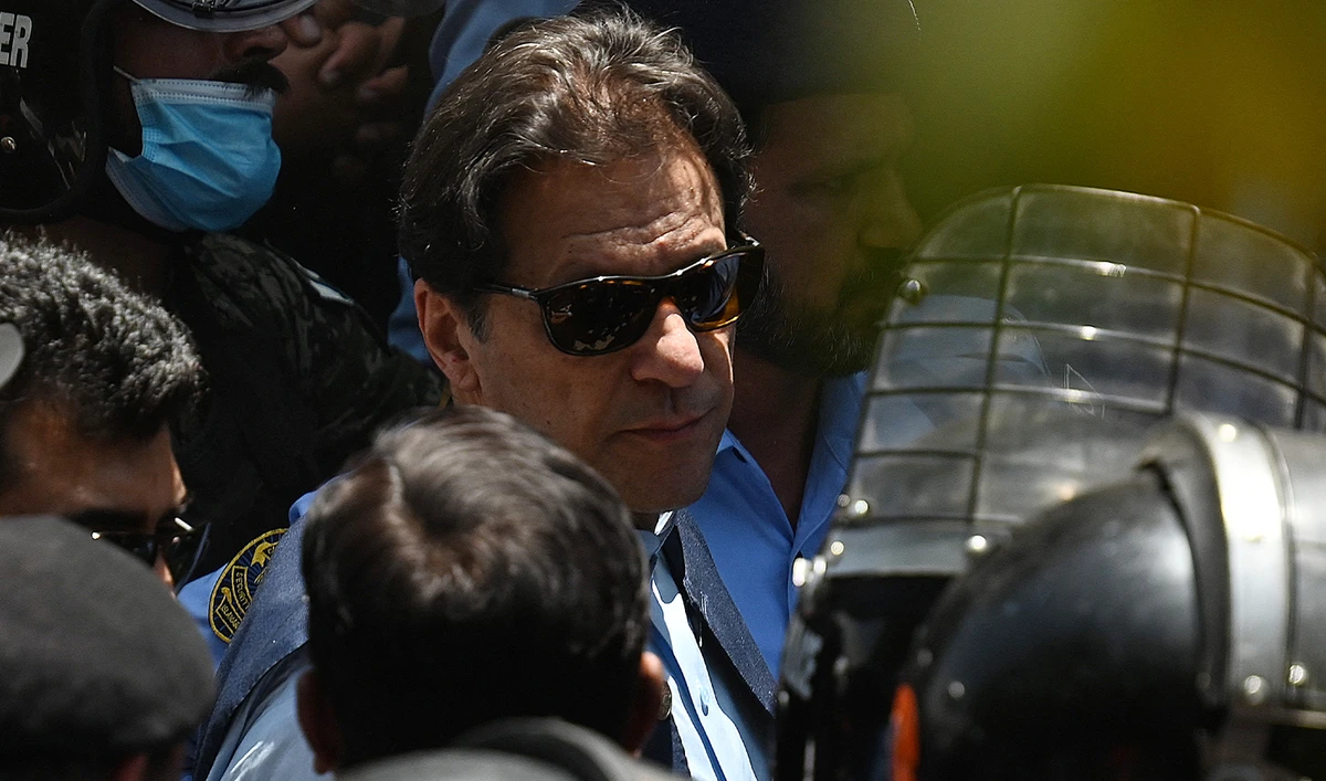 Police cammandos escort former Pakistan's Prime Minister Imran Khan (C) as he arrives at the high court in Islamabad on May 12, 2023. (AFP/File)