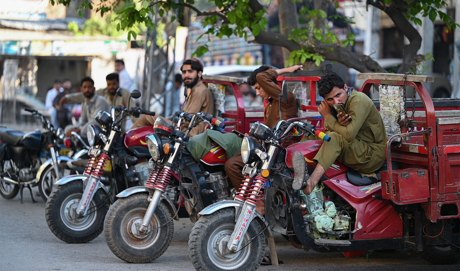 Rickshaw drivers wait for customers in a market in Rawalpindi, Pakistan, on June 13, 2024. (AFP/File)