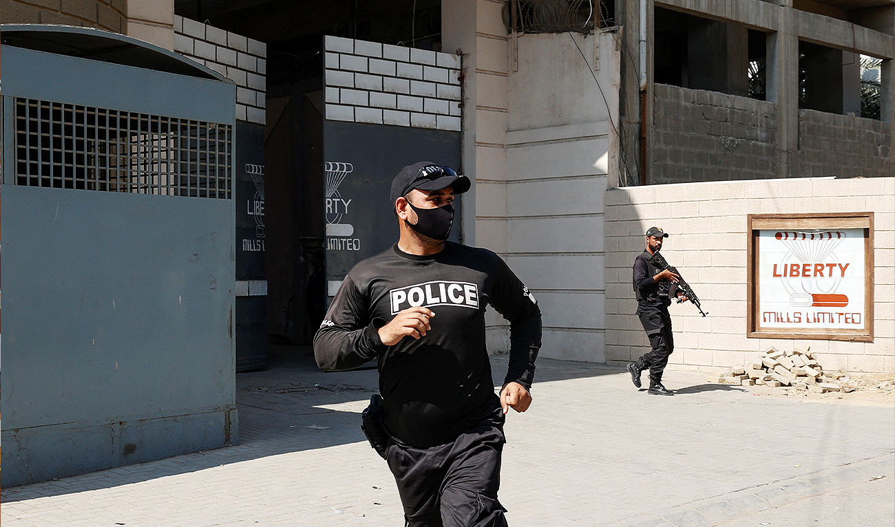 Police officers guard outside a factory where, according to police, two Chinese nationals were shot and injured, in Karachi, Pakistan on November 5, 2024. (REUTERS)