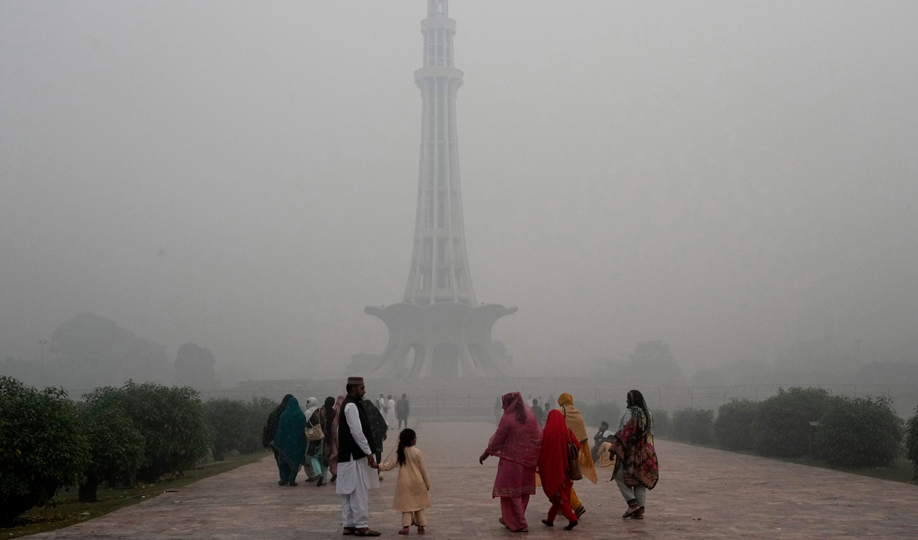Families arrive at Minar-e-Pakistan or Pakistan monument as smog envelops the area of Lahore on November 8, 2024. (AP)