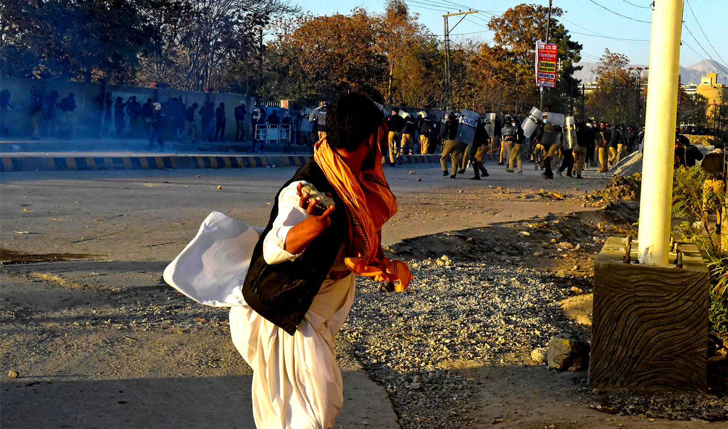Pakistan Tehreek-e-Insaf (PTI) party's supporter throws stone towards police during a protest to demand the release of former prime minister Imran Khan, in Quetta on November 8, 2024. (AFP)