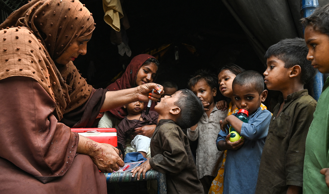 Health workers administer polio drops to children during a door-to-door vaccination campaign in Lahore on October 28, 2024. (AFP)