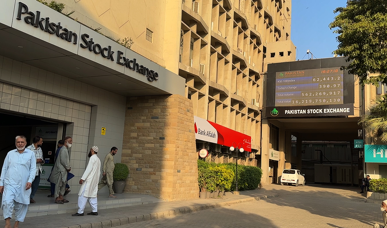 In this photo, taken on December 29, 2023, workers interact outside the Pakistan Stock Exchange in Karachi. (AN Photo/File)