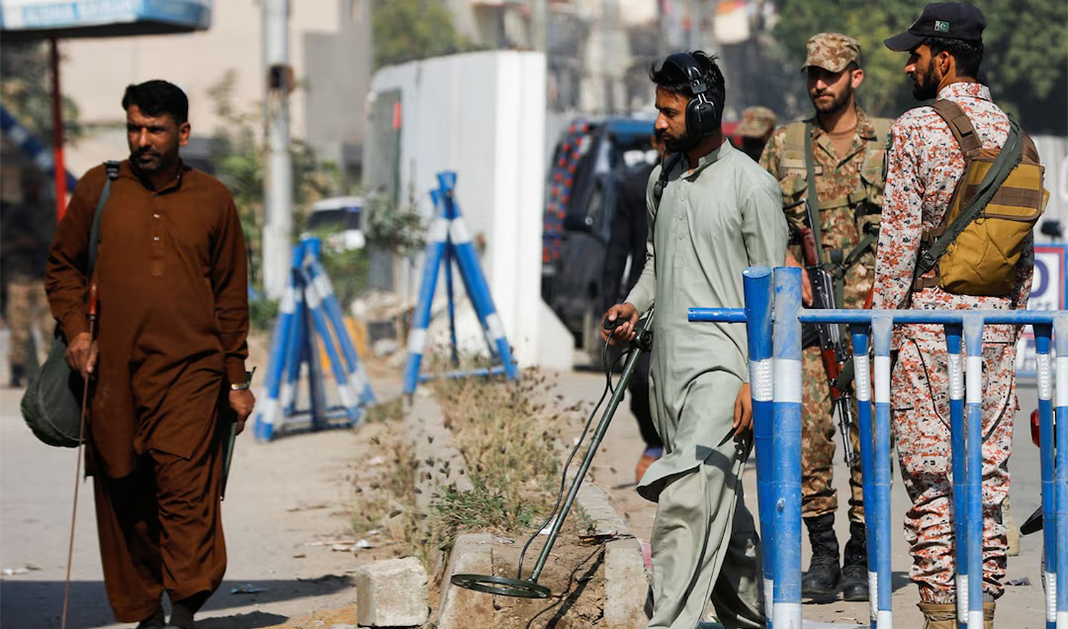 Members of the bomb disposal squad in plain clothes, survey the area after yesterday's attack on a police station, in Karachi, Pakistan on February 18, 2023. (REUTERS/File)