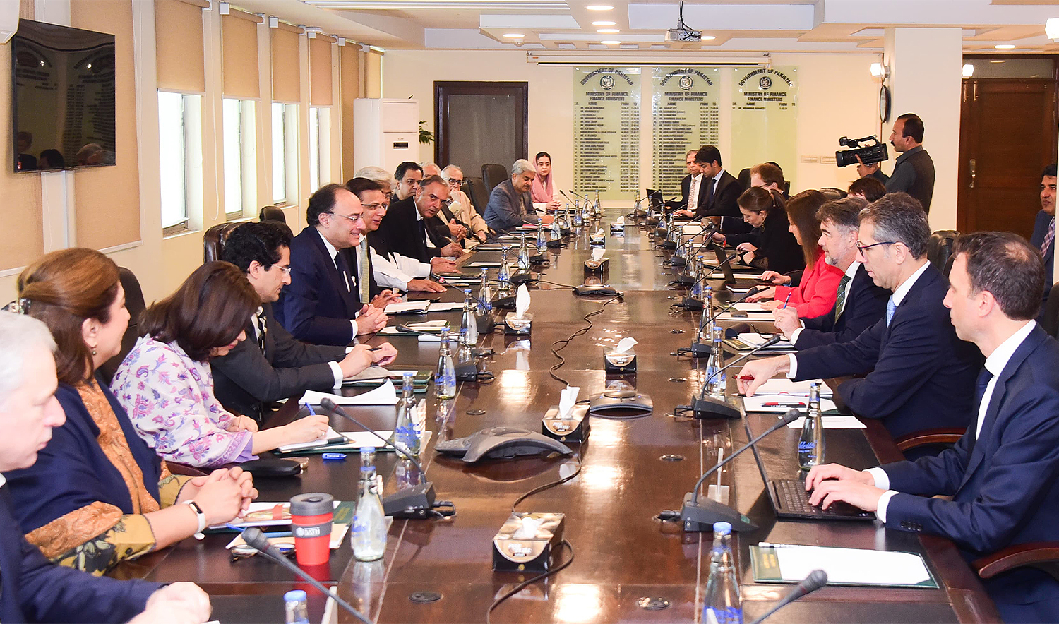 This handout photograph released by the Pakistan Press Information Department (PID) on November 12, 2024, shows Pakistan’s Finance Minister Muhammad Aurangzeb (5L) meeting with a International Monetary Fund (IMF) review mission led by Nathan Porter (3R) at the Finance Ministry in Islamabad on November 11, 2024. (PID/File)
