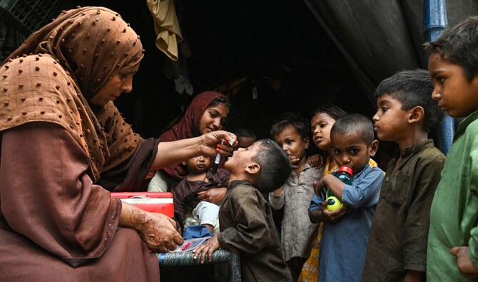Health workers administer polio drops to children during a door-to-door vaccination campaign in Lahore on October 28, 2024. (AFP)