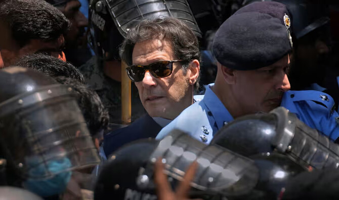 Police cammandos escort former Pakistan's Prime Minister Imran Khan (C) as he arrives at the high court in Islamabad on May 12, 2023. (AFP/File)