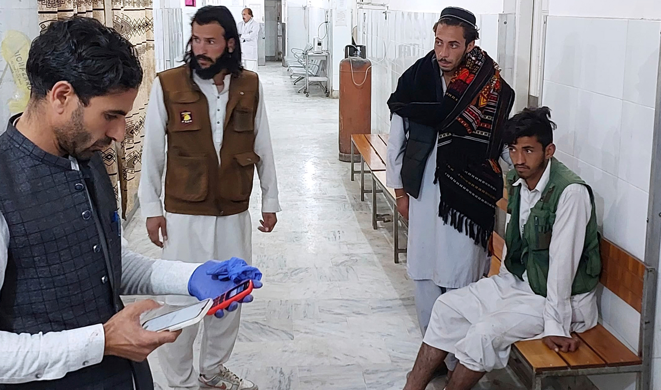 An injured victim, right, of gunmen firing incident on a passenger vehicle, is treated at a hospital in Parachinar, in Kurram district of Pakistan's northwestern Khyber Pakhtunkhwa province on November 21, 2024. (AP)