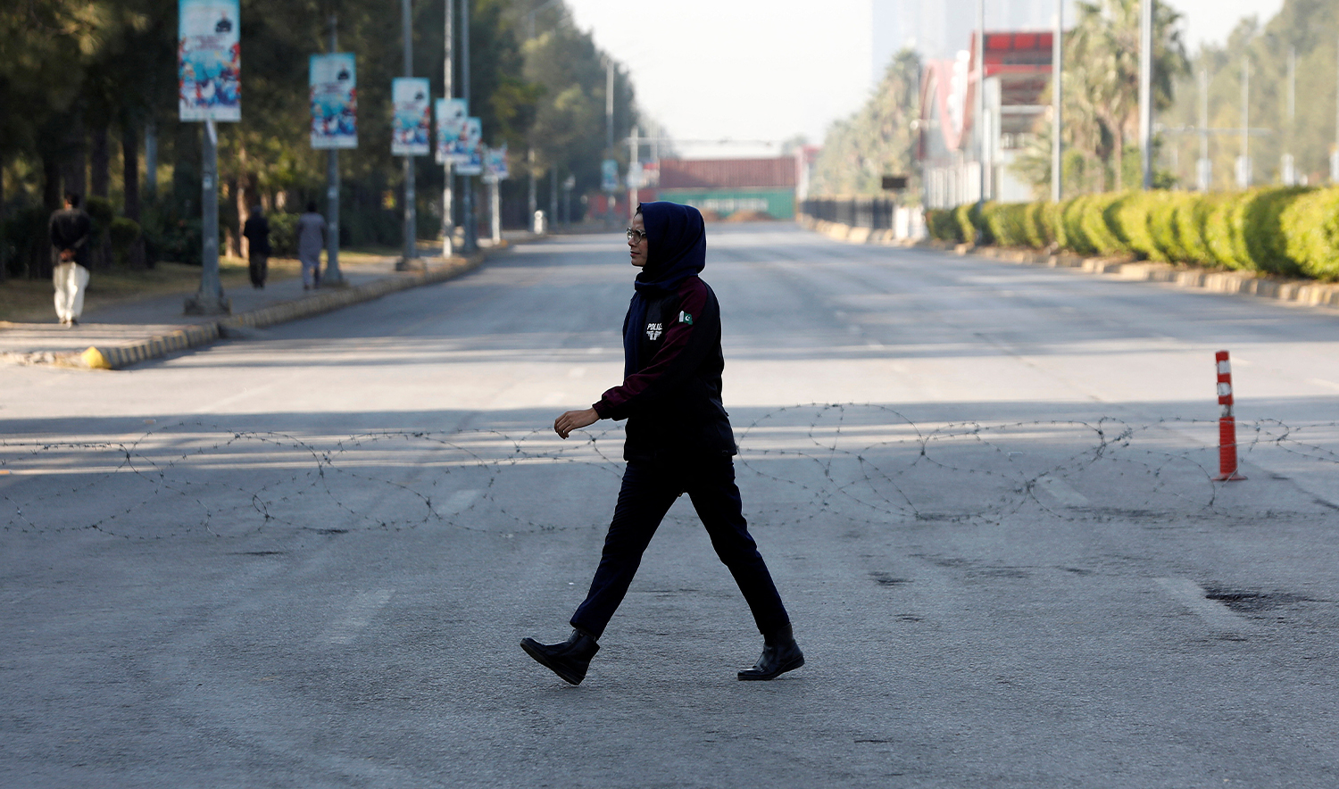 A police officer walks past a wire laid across a road to prevent an anti-government rally by supporters of the former Pakistani Prime Minister Imran Khan's party Pakistan Tehreek-e-Insaf (PTI) in Islamabad, Pakistan, on November 25, 2024. (REUTERS)
