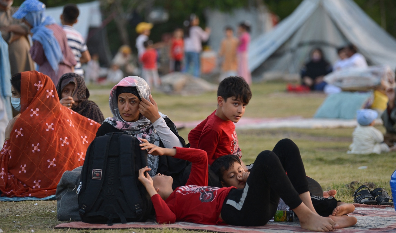 Afghan refugees seeking asylum abroad gather at an open field in protest to demand help from the United Nations High Commissioner for Refugees (UNHCR), in Islamabad on May 7, 2022. (AFP/File)