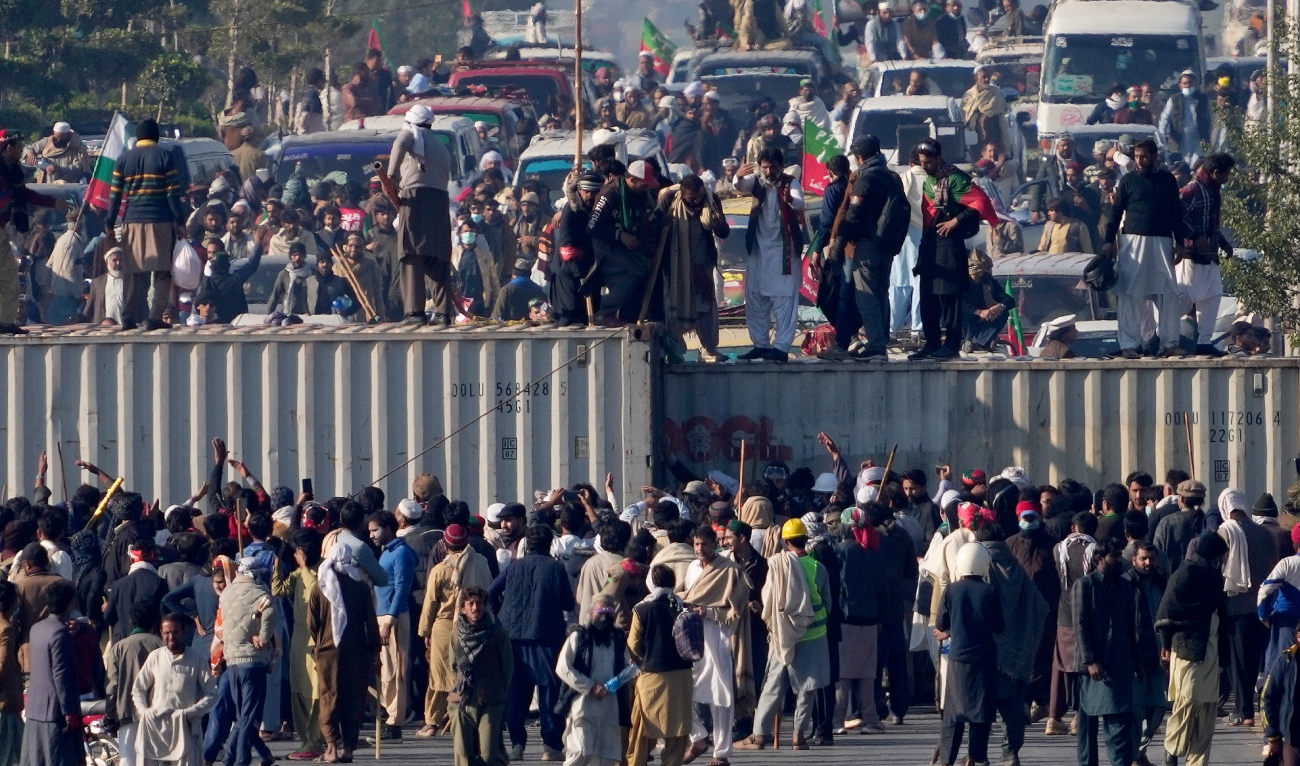 Image Caption : Supporters of imprisoned former premier Imran Khan's Pakistan Tehreek-e-Insaf party, remove shipping container to clear way for their rally demanding Khan's release, in Islamabad, Pakistan, on November 26, 2024. (AP)