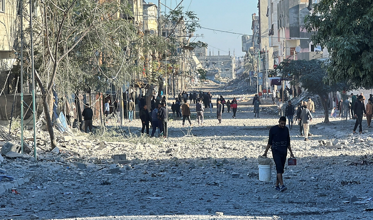 Palestinians inspect the site of an Israeli air strike on a residential building, amid the ongoing conflict between Israel and Hamas, in Nuseirat in the central Gaza Strip on November 28, 2024. (REUTERS)