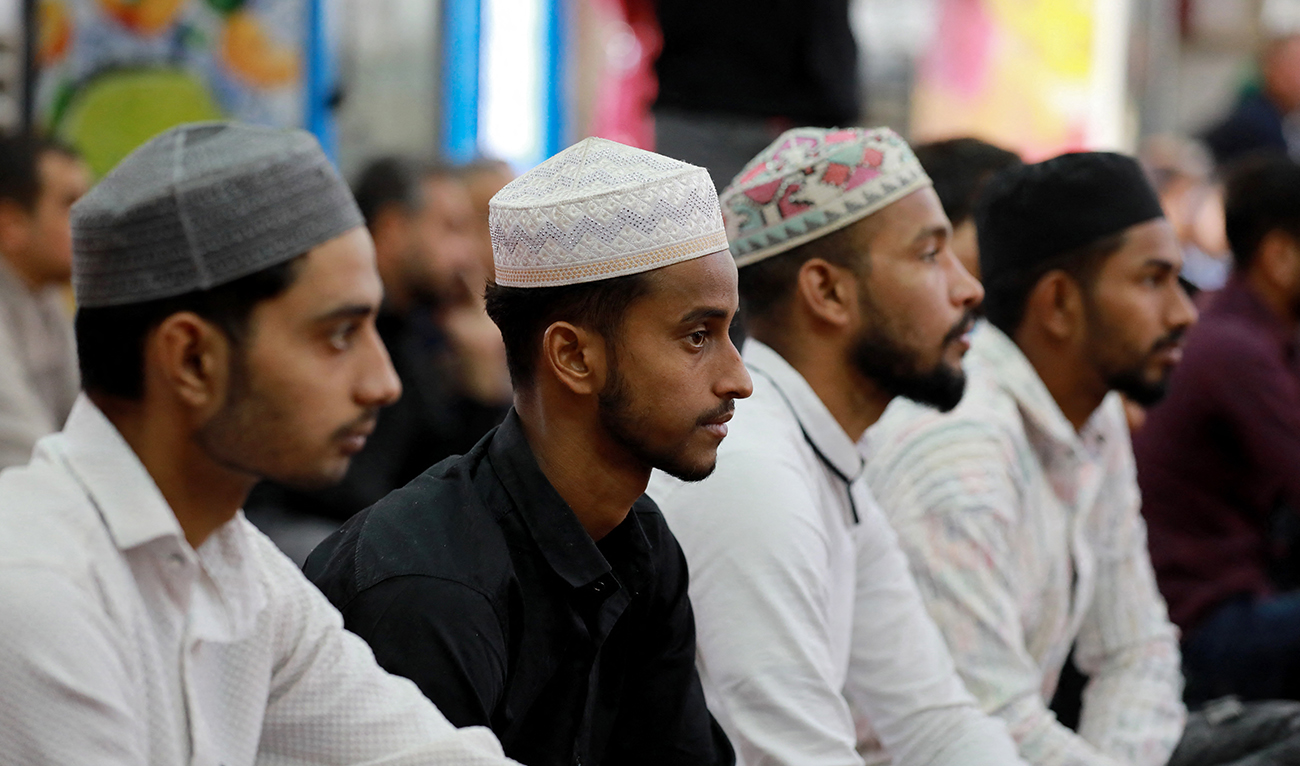 Muslim foreign workers based in Iraq attend a prayer at Baghdad’s Abdul Qader Al-Jilani mosque on November 22, 2024. (AFP)