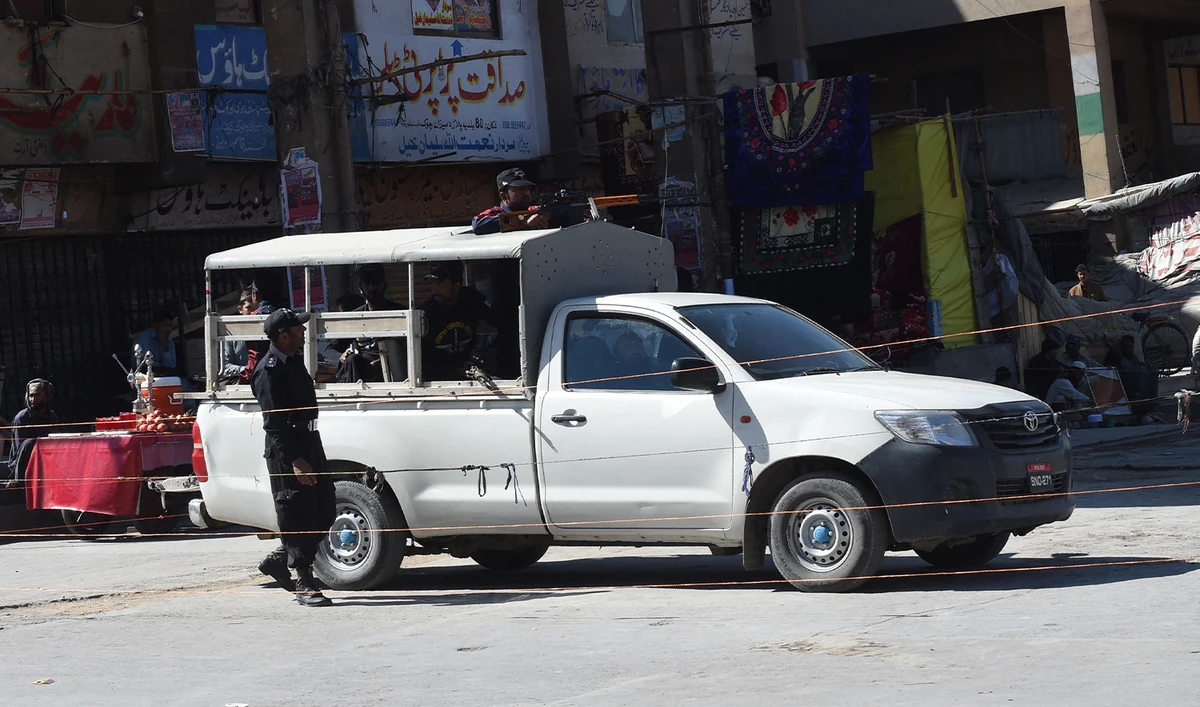 Pakistani policemen stand guard in front of shuttered shops at the market during a strike in Quetta on October 26, 2016, a day after the militants' attack on the Balochistan Police College. (AFP/File)