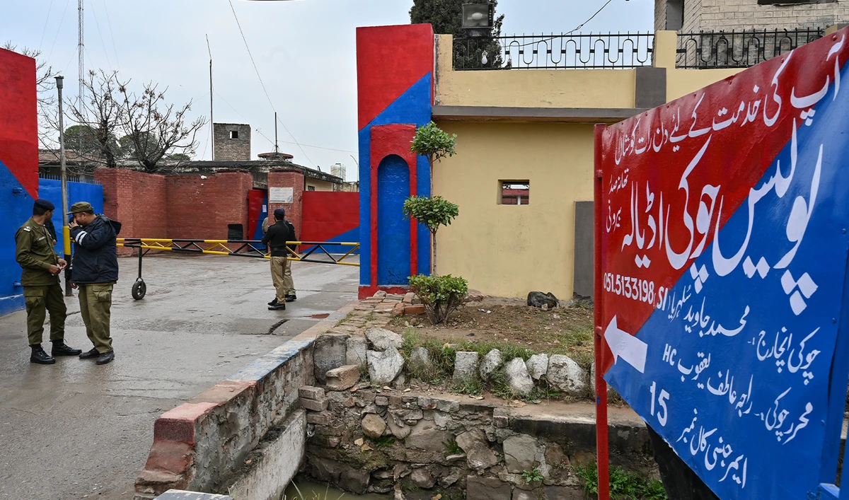 Police personnel stand guard near a signboard reading 'police check post Adiala' at the entrance of Adiala jail after the hearing of Pakistan's jailed former Prime Minister Imran Khan in Rawalpindi on January 31, 2024. (AFP/File)