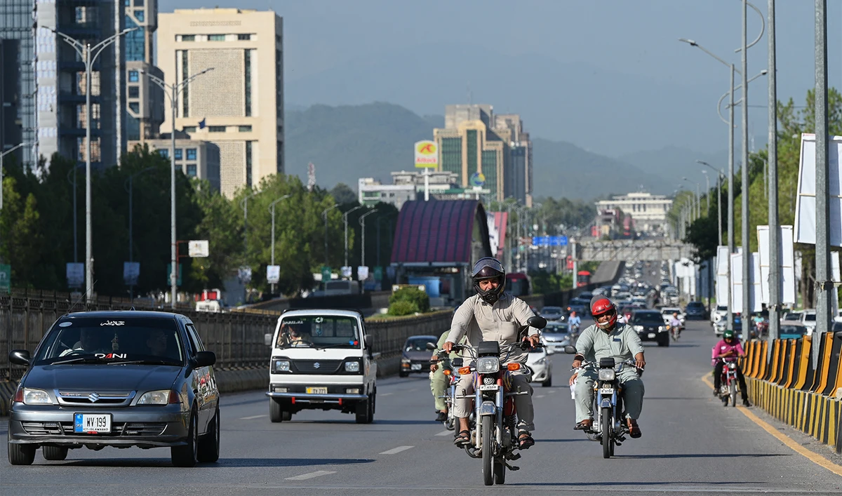 People commute on a road in Islamabad on July 11, 2023. (AFP/File)