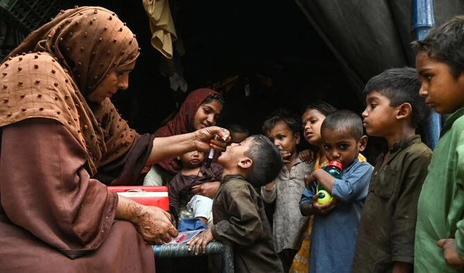 Health workers administer polio drops to children during a door-to-door vaccination campaign in Lahore on October 28, 2024. (AFP/File)