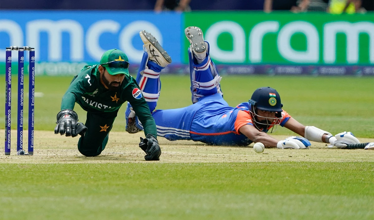 Pakistan's wicket keeper Mohammad Rizwan (L) dives for the ball during the ICC men's Twenty20 World Cup 2024 group A cricket match between India and Pakistan at Nassau County International Cricket Stadium in East Meadow, New York on June 9, 2024. (AFP/File)