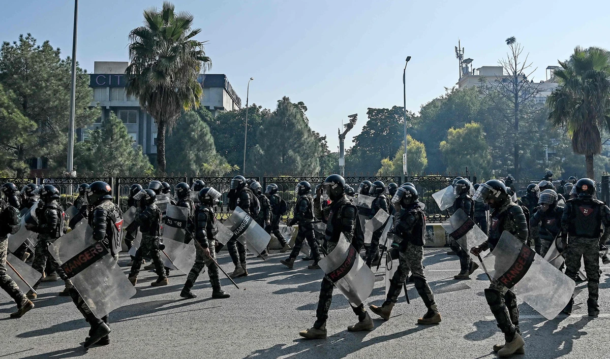 Paramilitary soldiers march along a street leading to the Red Zone area during a protest by the supporters of the Pakistan Tehreek-e-Insaf (PTI) party demanding the release of former prime minister Imran Khan, at the Red Zone area in Islamabad on November 26, 2024. (AFP/File)