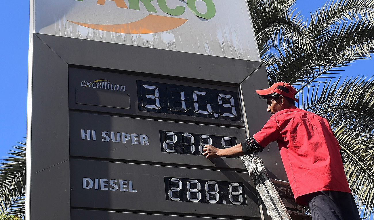 In this file photograph, taken on February 16, 2023, an employee of a petrol station updates the latest fuel prices on a board in Karachi. (AFP/File)