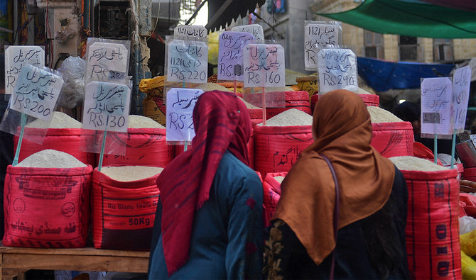 In this picture taken on January 10, 2023, women check rice prices at a main wholesale market in Karachi. (AFP/File)
